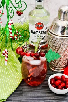 a table topped with bottles and glasses filled with liquid, candy canes and candies