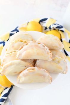 glazed donuts on a plate with lemons and blue and white napkin around them