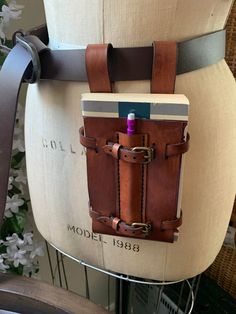 a brown leather bag sitting on top of a chair