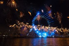 fireworks are lit up in the night sky over water