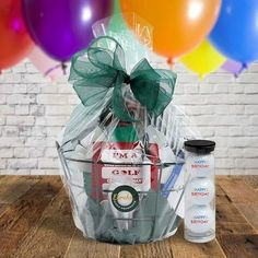 a gift basket filled with drinks and balloons