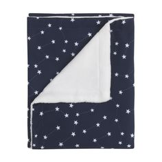 a blanket with white stars on it and a navy blue background, folded in half