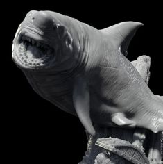 a statue of a shark with it's mouth open