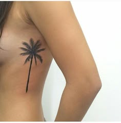 a woman with a palm tree tattoo on her chest