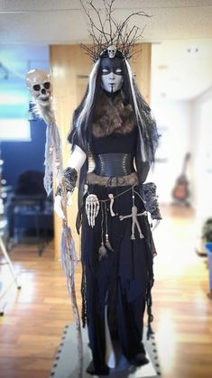 a woman dressed in black and white with skeleton decorations