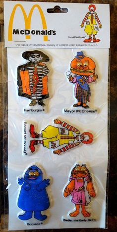 the mcdonald's characters are on display in plastic bags with stickers attached to them