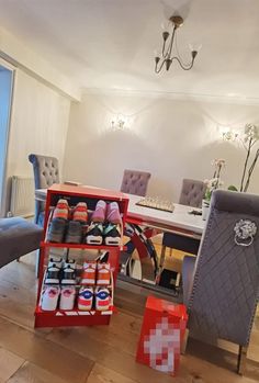 a dining room table with several pairs of shoes on display in front of the chairs