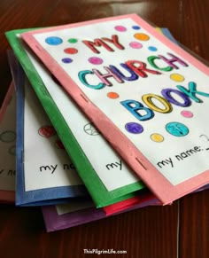 four books with the words my church book written on them and colored papers stacked up next to each other