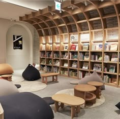 the library is full of books and furniture for people to sit on, read or relax