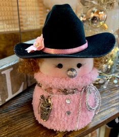 a stuffed animal wearing a pink coat and hat