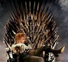 a woman sitting on top of a iron throne