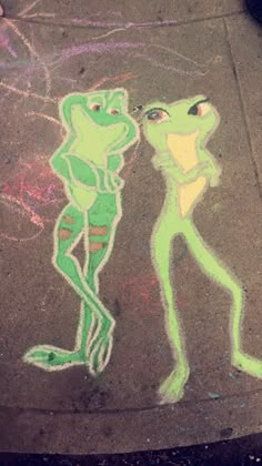 a drawing of a frog and a man on the sidewalk with chalk pasted onto it