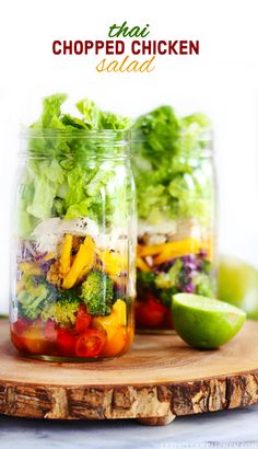 two mason jars filled with salad and vegetables