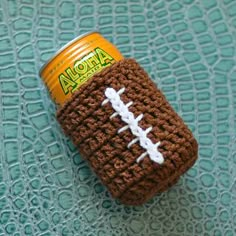 a crocheted can holder with a football on it