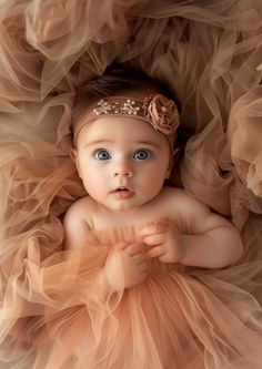 a baby girl wearing a dress and headband