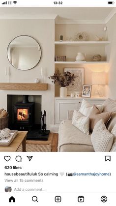 a living room filled with furniture and a fire place in front of a mirror on the wall