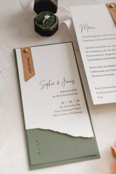 the wedding stationery is laid out on the table