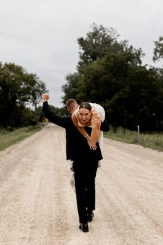 Groom walks away carrying bride over his shoulder as he celebrates with a fist in the air while bride flashes a smile and shows off her stunning wedding ring. Unique Wedding Poses, Fun Wedding Pictures, Bride Groom Poses, Wedding Couple Photos