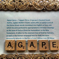 the word agape spelled with scrabbles in front of an ornate frame