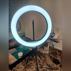 a light that is sitting on top of a table next to a mirror and other items