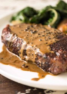 steak with gravy and vegetables on a plate