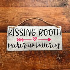 a wooden sign that says kissing booth pick up buttercup