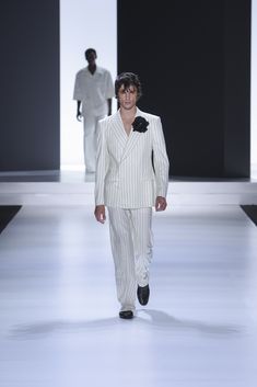 Fernando Lindez wears a double-breasted Sicilia jacket and 28-bottom trousers, both made of pinstripe wool fabric. Wool Fabric, Double Breasted