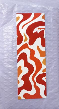 an orange and white pattern on a piece of paper