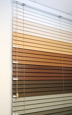 the blinds are lined with different shades of wood