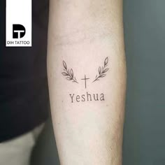 a person with a tattoo on their arm that says yeshuaa and an olive branch