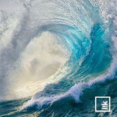 a large blue wave is breaking in the ocean