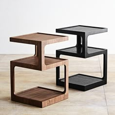 three wooden and metal side tables sitting on top of a tile floor next to each other