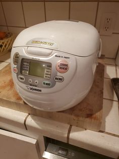 a white rice cooker sitting on top of a counter