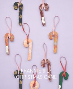 six ornaments are hanging on a purple background with the words franie silk christmas cane