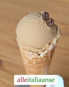 an ice cream cone with coffee beans on top and the words alletalianse above it