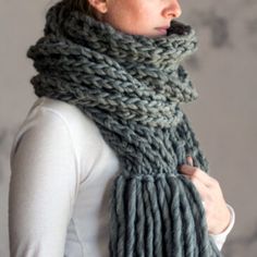 a woman wearing a gray knitted scarf