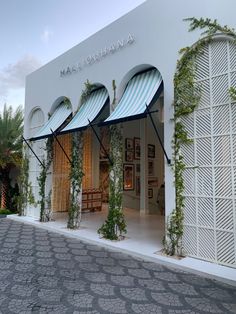 a store front with blue and white awnings