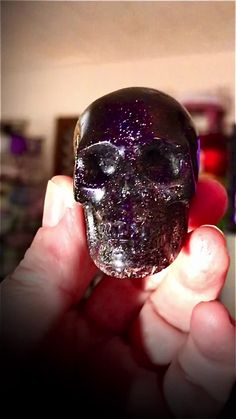 a person holding up a crystal skull in their hand