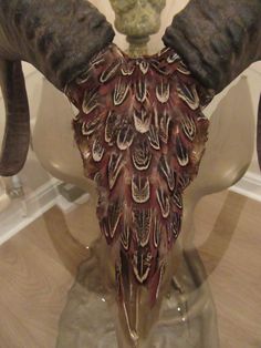 an elephant's tusks are adorned with feathers