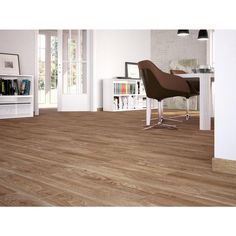 a living room with white walls and wood flooring on the floor, along with bookshelves