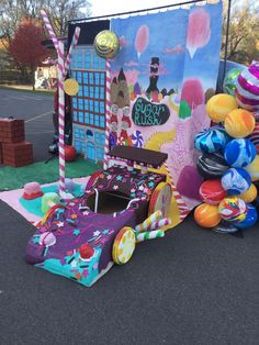 a car made out of balloons sitting on the ground