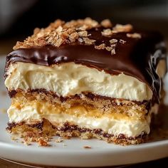 a piece of cake on a plate with chocolate and cream frosting in the middle