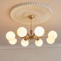 a chandelier hanging from the ceiling in a room