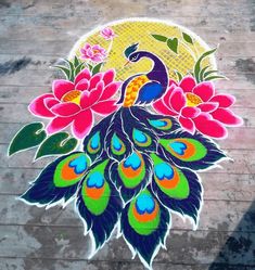 a painted peacock on the ground with flowers