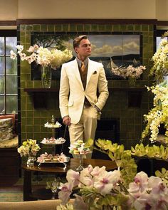 the great gatsby movie poster with a man standing in front of a fireplace