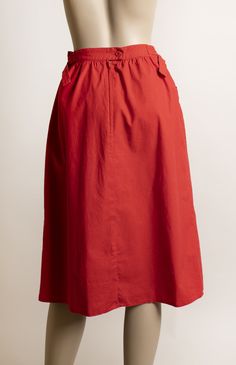 "FREE DOMESTIC SHIPPING! <3 ♥ Adorable vintage 1970s cherry red cotton skirt with front pockets and D-ring waistline! ♥ Nylon zipper in the back with a button closure. ♥ Cute deep, front pockets. ♥ Knee length, straight style cut. ♥ Fun D-ring waistline, lets you cinch the waist in if needed. Ends of strips will lay to the side (modeled to the back to show details) ♥ In great condition! Minimal wear (possibly from iron?) on seams. Cotton, made in Belgium! * measurements * Waist - 26\", could Red Cotton Flared Skirt Bottoms, Red Cotton Long Skirt, Red Flared Cotton Skirt, Cotton Skirt With Pockets For Daywear, Red Cotton Flared Skirt, Red Midi Skirt With Elastic Waistband, Red Cotton Midi Skirt, Red Spring Skirt With Pockets, Red Skirt With Pockets For Spring