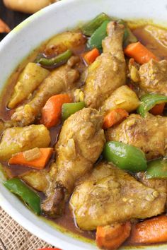 a white bowl filled with meat and vegetables