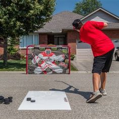 a man in red shirt throwing a frisbee on top of a white board