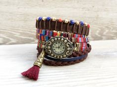 Bohemian watch bracelet Colorful wristwatch Wrap Boho watch Multicolor Boho Watch for Woman gift Boho Rainbow Watch Brown Red Watch  Bohemian watch bracelet with a colorful textile band and quartz mechanism. This wrap boho watch can be worn as a spectacular boho jewelry. A perfect gift for a friend or for the woman you love. It has two separate bracelets to the watch: - the first bracelet is made from a brown suede band, brown cotton cord, and blue, red, and gold glass beads - the second one is made from brown and dark blue suede cord You can order wristwatch only or wristwatch and one or the two bracelets as follow: - All Set - you will receive the wristwatch and the both bracelets - Wristwatch only - you will receive the wristwatch only - Watch+Beads Bracelet - you will receive wristwatc Multicolor Analog Watches As Gift, Multicolor Analog Watches For Gift, Gift Multicolor Analog Watches, Adjustable Bohemian Style Watches As Gift, Bohemian Style Adjustable Watches As Gift, Multicolor Bracelet Strap Watch As Gift, Handmade Multicolor Watch Accessories For Gift, Multicolor Watches With Bracelet Strap As Gift, Bohemian Bracelet Strap Watch Accessories As Gift