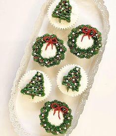 christmas cupcakes decorated with green and red decorations